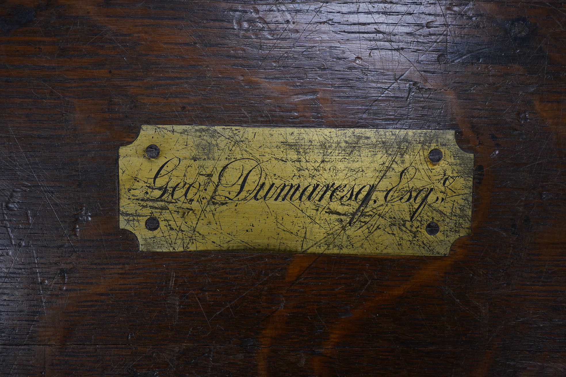 A 19th century wrought iron bound oak canteen, brass plaque inlaid to lid reads ‘Geo: Dumaresq. Esq’, 52cm wide. Condition - fair